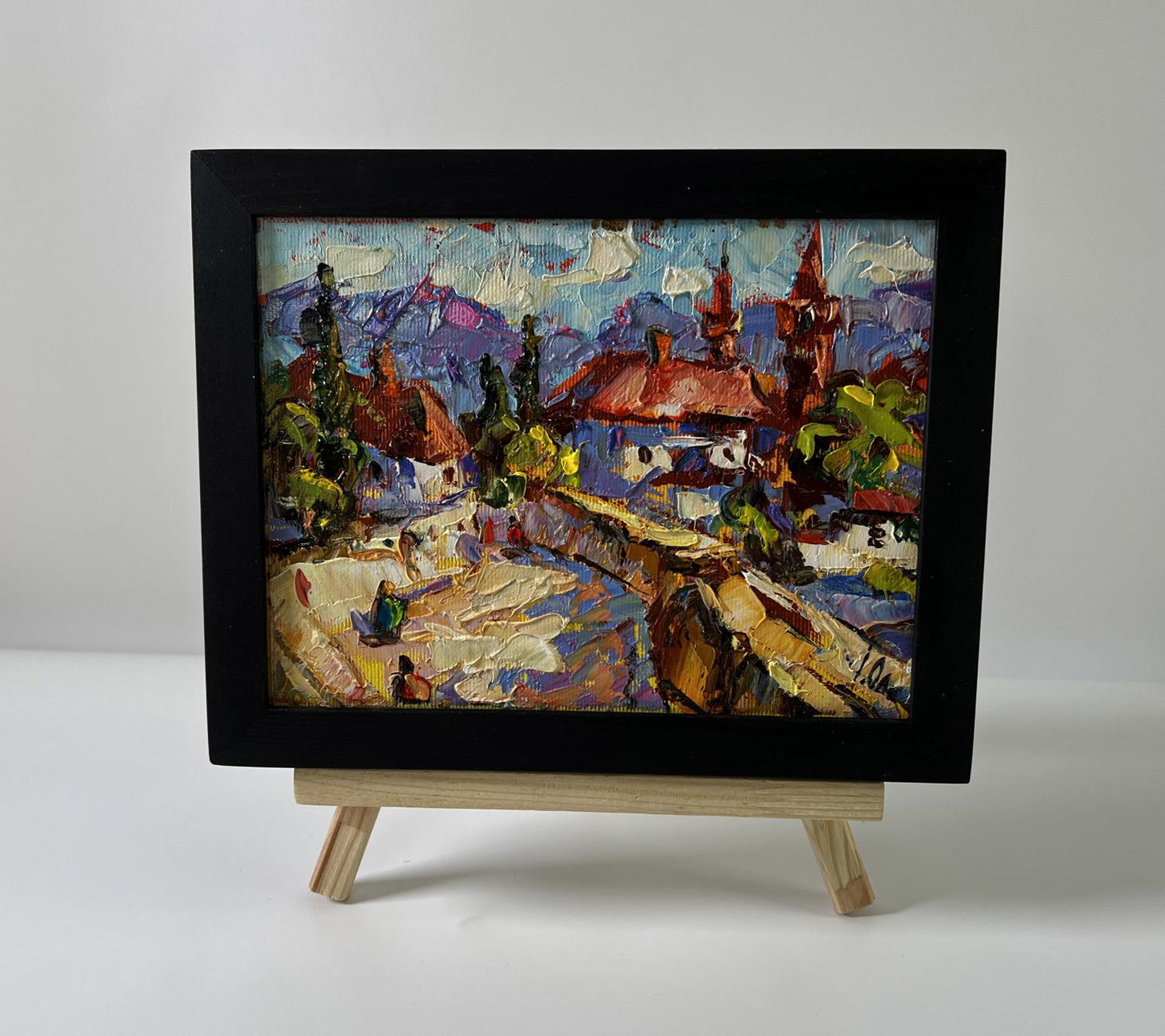 Vibrant impressionist oil painting of Oleksiy Ivanyuk old town walking tour with red roofs and mountains in black frame