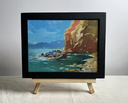 Framed oil painting of rocky seashore cliffside by Yuriy Suprunchuk