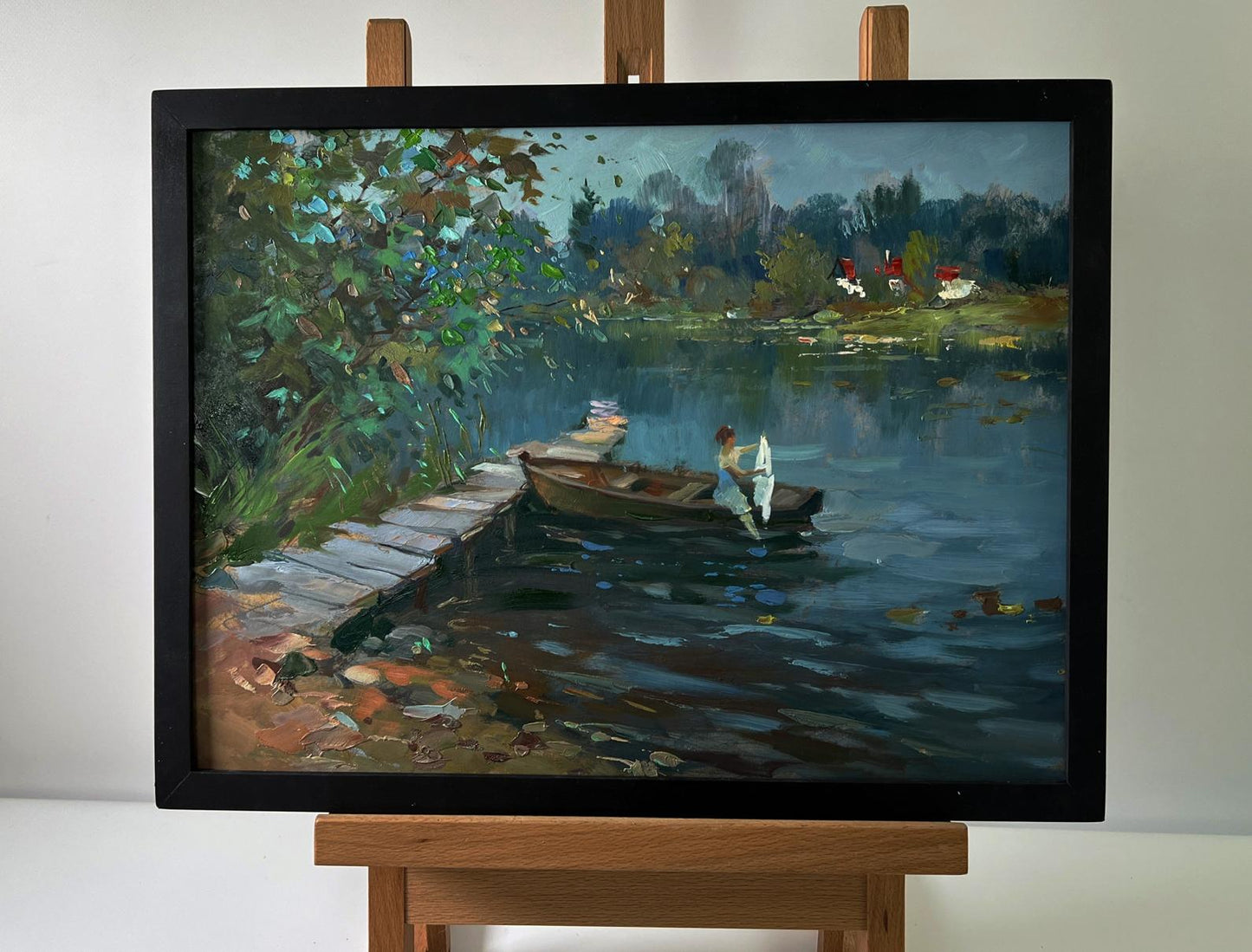 Framed oil painting of girl on boat in serene lakeside by Yuriy Suprunchuk