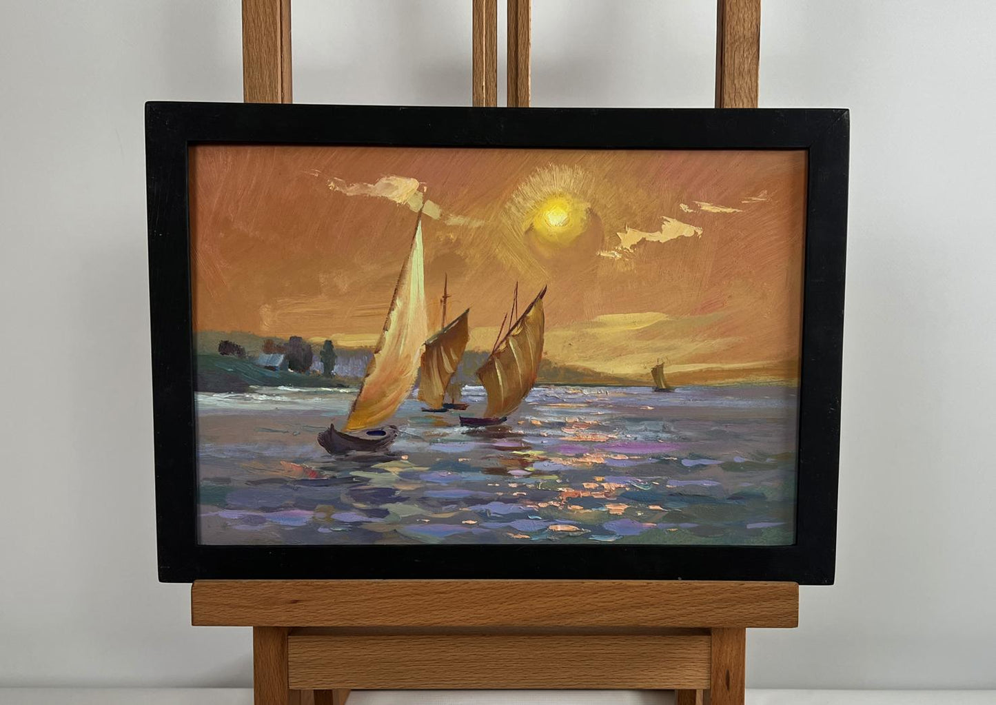 Framed oil painting of sailboats on sunset sea by Yuriy Suprunchuk