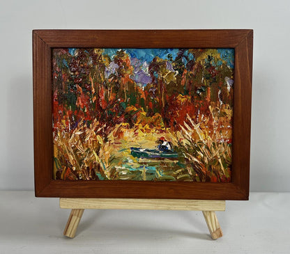 Oleksiy Ivanyuk oil painting of lake with autumn trees, boat, reeds in brown frame