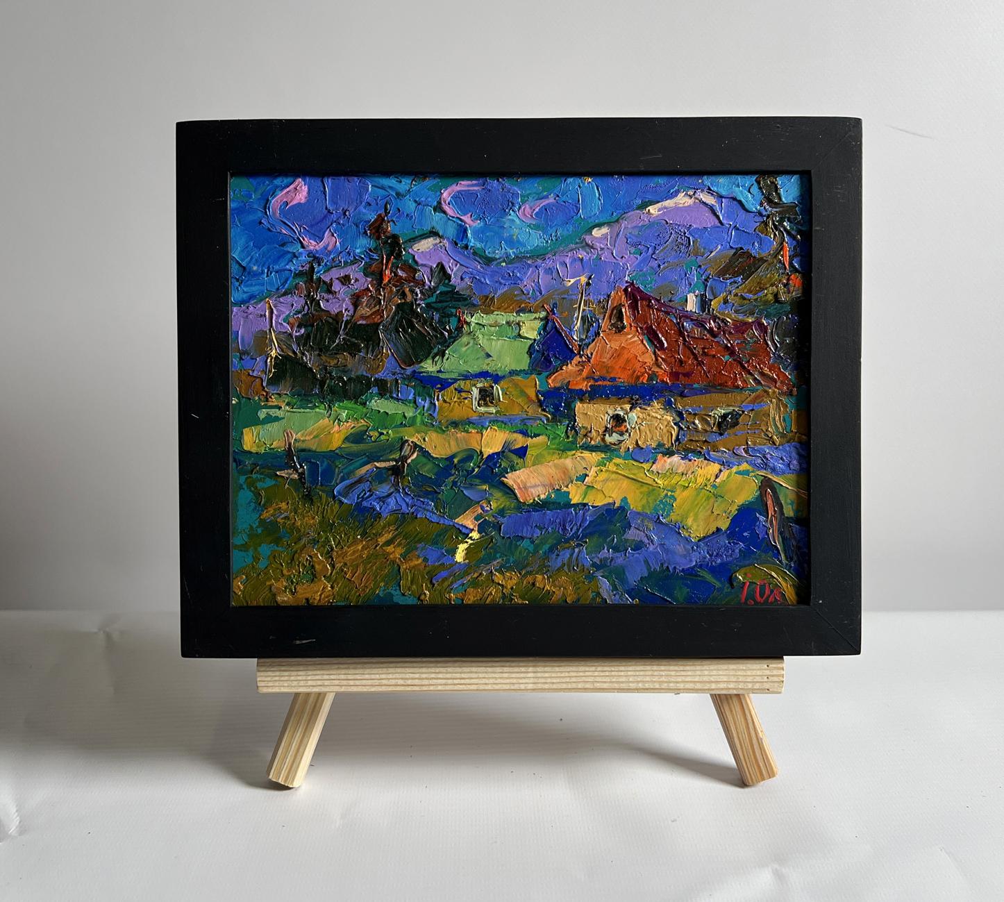 Oil painting of village and blue mountains by Oleksiy Ivanyuk in black frame