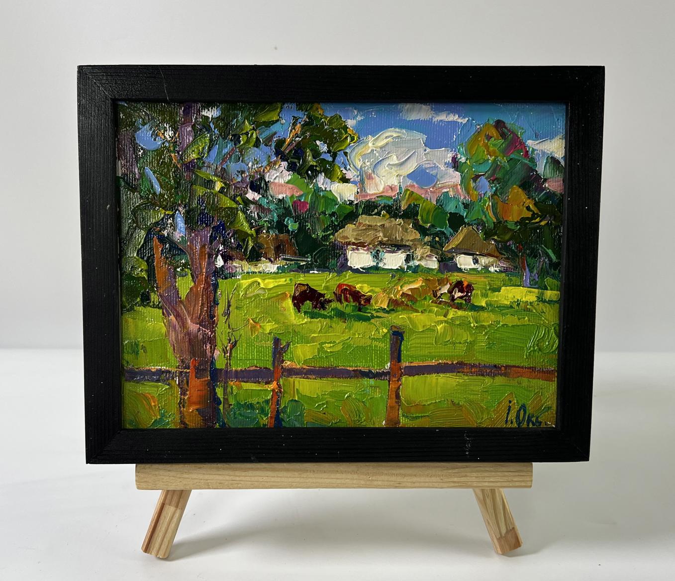 Oil painting by Oksana Ivanyuk: cows grazing in lush green meadow, framed