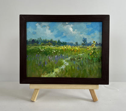 Oil painting of sunflower fields in sunlit meadow by Yuriy Suprunchuk