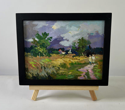 Black-framed oil painting Quiet Village in Endless Expanses by Yuriy Suprunchuk