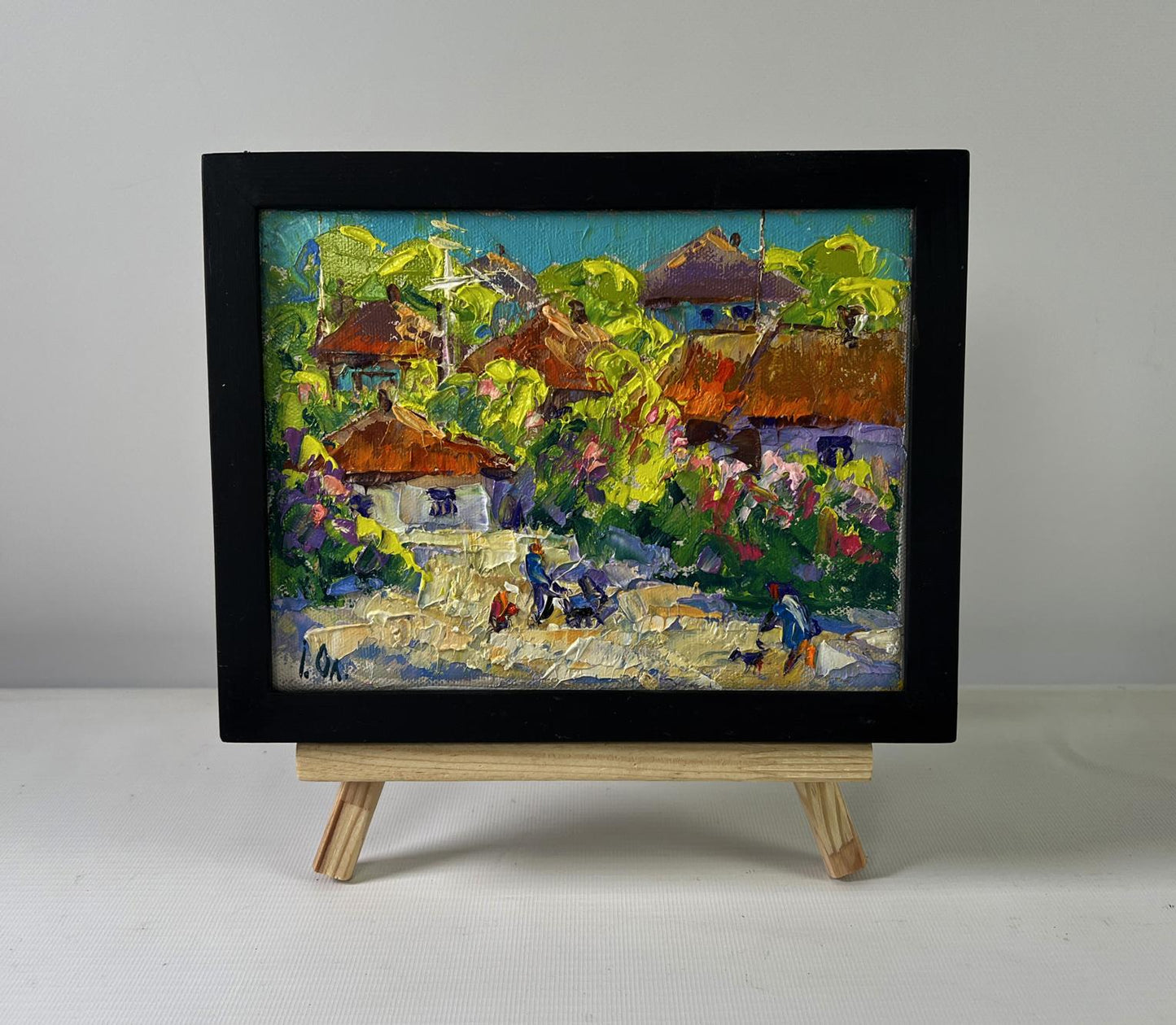 Oil painting Bloom and Light Between Buildings by Oleksiy Ivanyuk in black frame