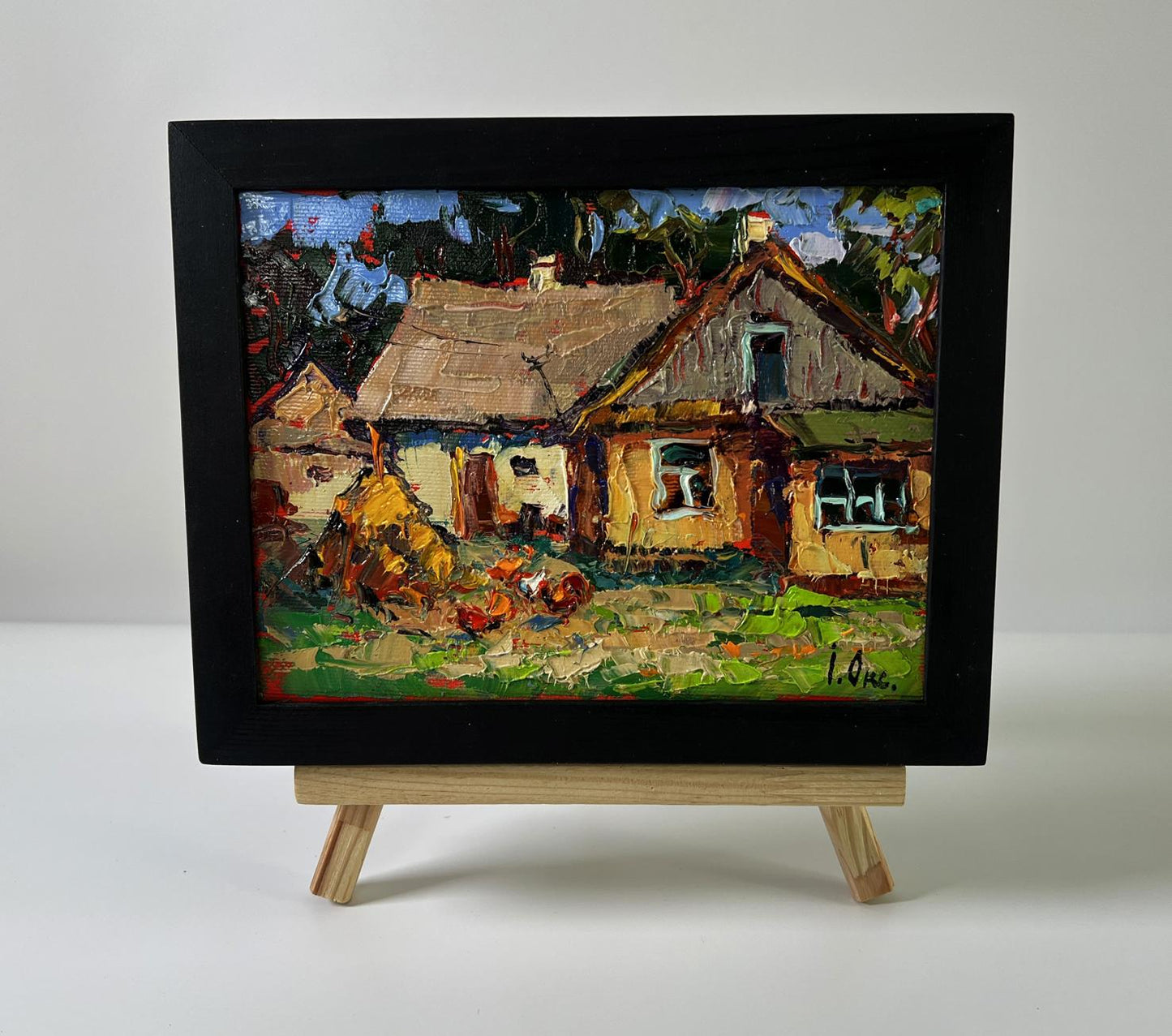 Oil painting Silence in a village house by Oksana Ivanyuk in black frame