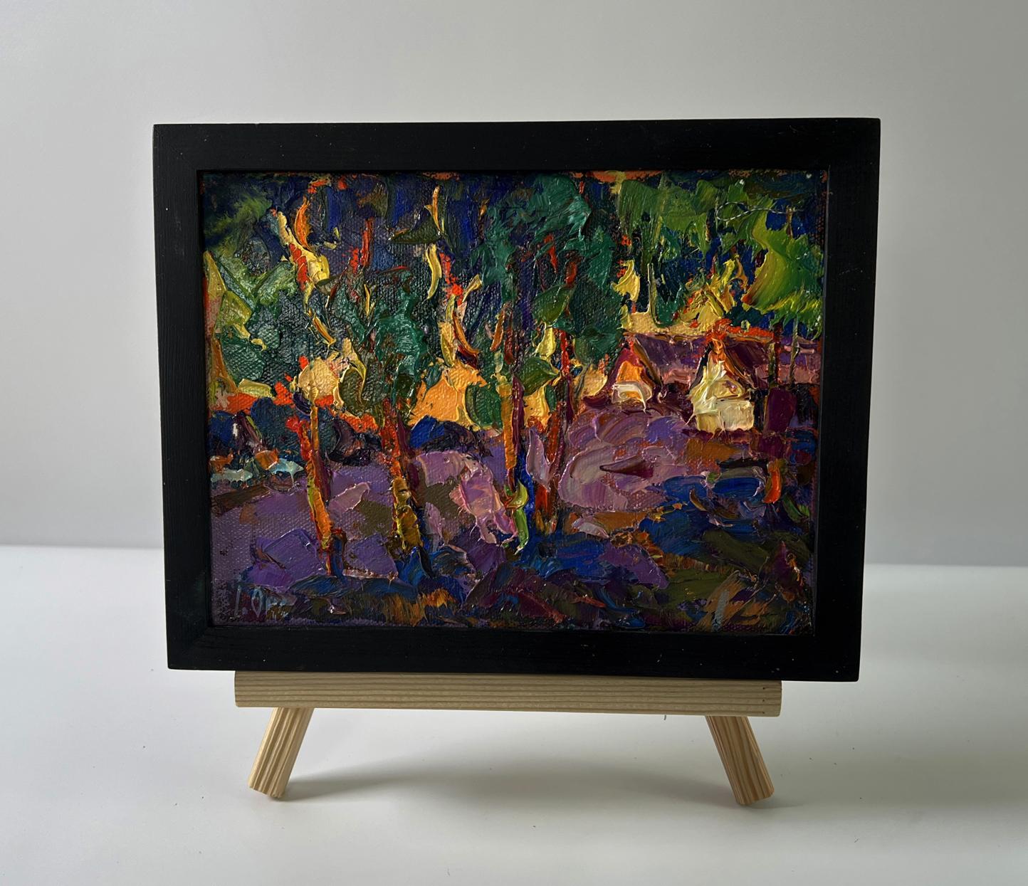 Oil painting of orange sunset behind trees by Oksana Ivanyuk in black frame