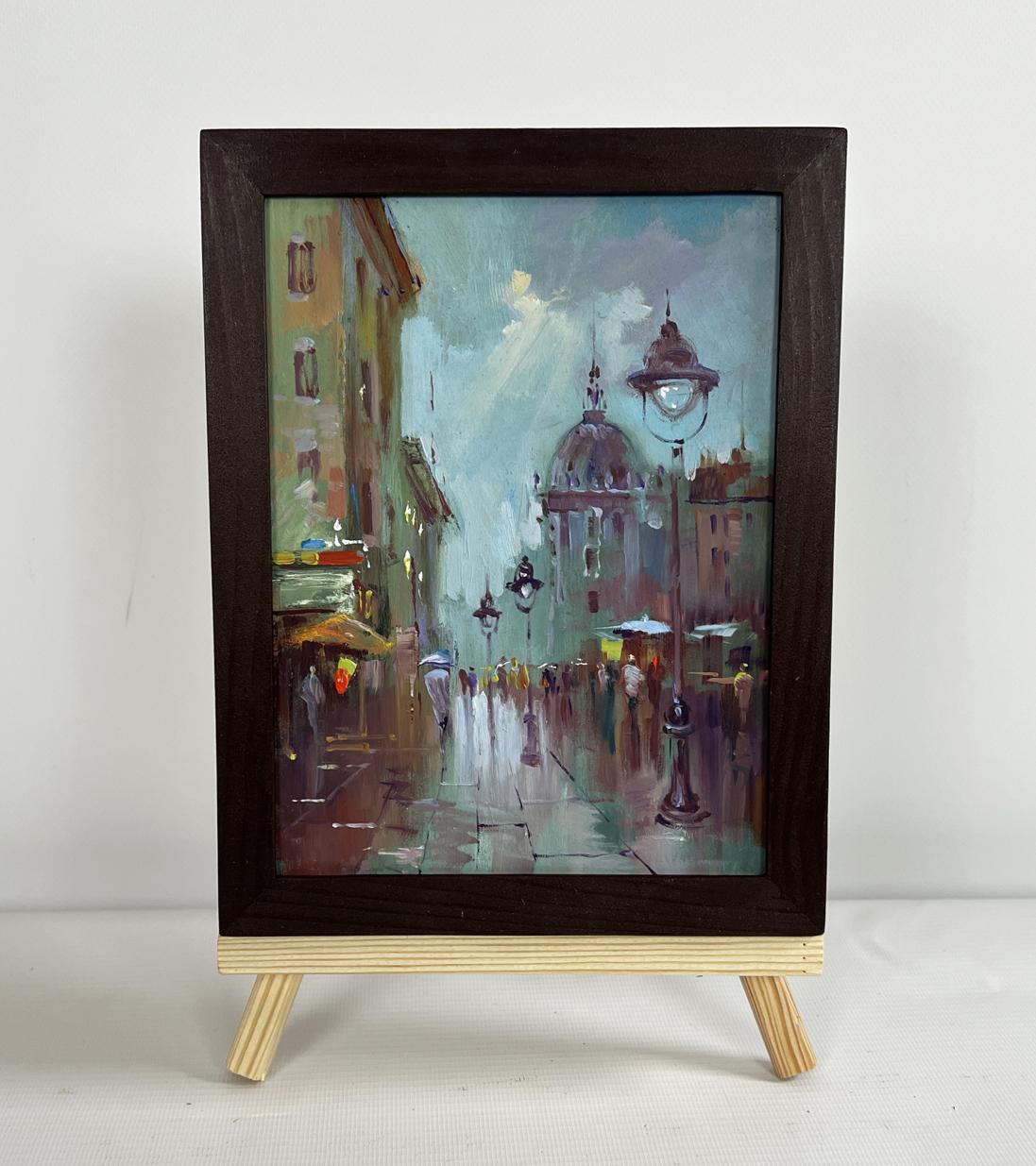 Framed oil painting of rainy city street hustle by Yuriy Suprunchuk