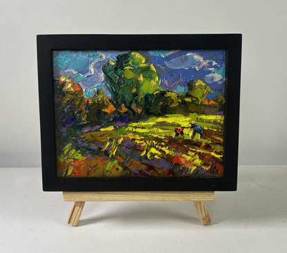 Vibrant Oleksiy Ivanyuk oil painting of lush green garden fields under swirling blue sky in black frame