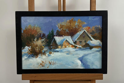 Framed oil painting by Yuriy Suprunchuk: snow-covered houses with brown roofs