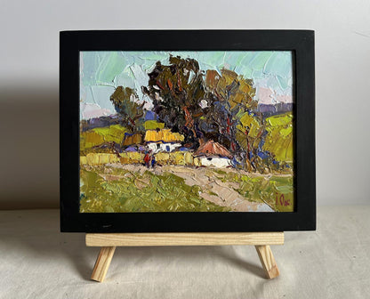Oil painting of village houses by Oksana Ivanyuk, impressionist rural landscape in black frame