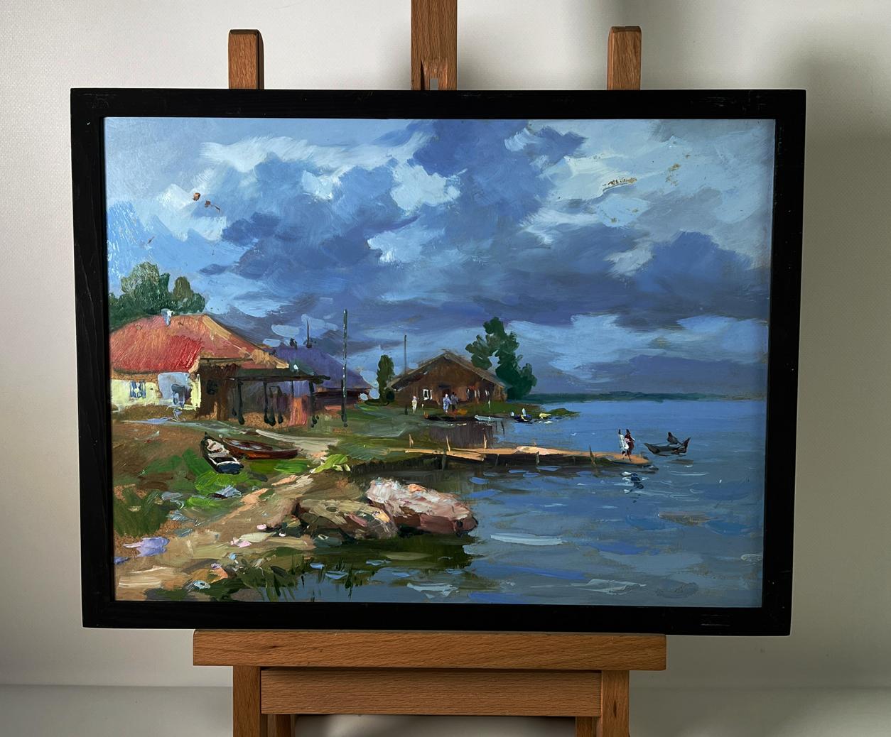 Oil painting by Yuriy Suprunchuk: houses near river bank lakeside village