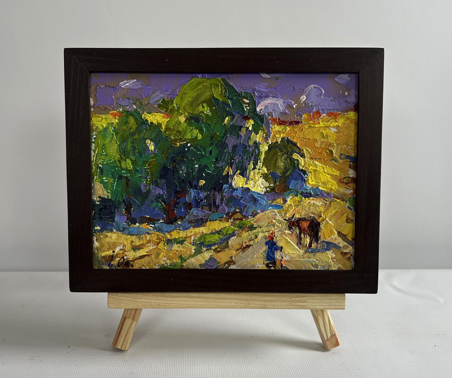 Vibrant impressionist oil painting by Oleksiy Ivanyuk: cow in lush green fields under purple sky, framed