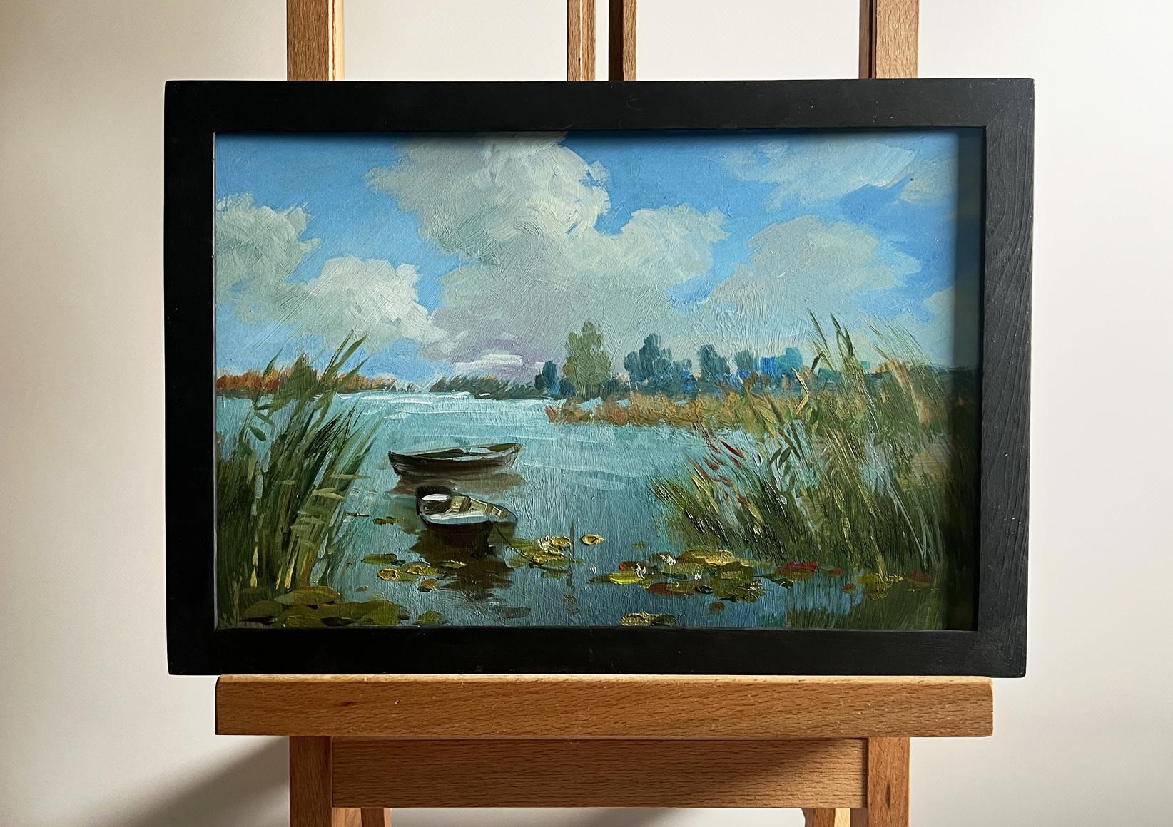 Oil painting by Yuriy Suprunchuk: serene lakeside with boats, reeds, lily pads