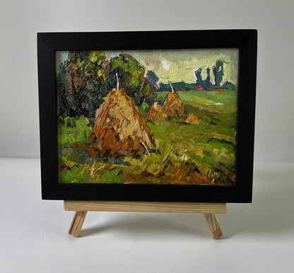 Oil painting Haystacks in the field by Oksana Ivanyuk on wooden easel