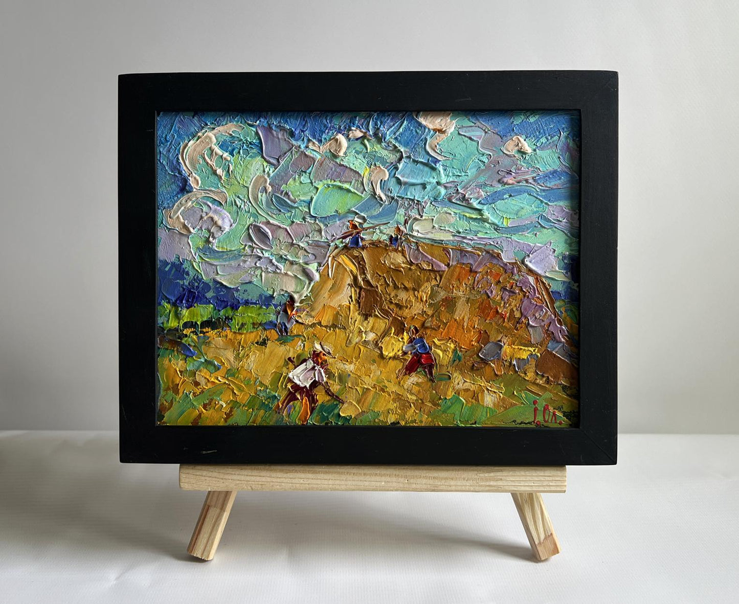 Oil painting Working in the field with hay by Oleksiy Ivanyuk in black frame