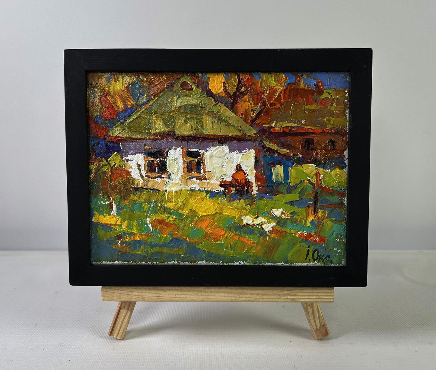 Vibrant impressionistic oil painting of rustic village by Oksana Ivanyuk in black frame