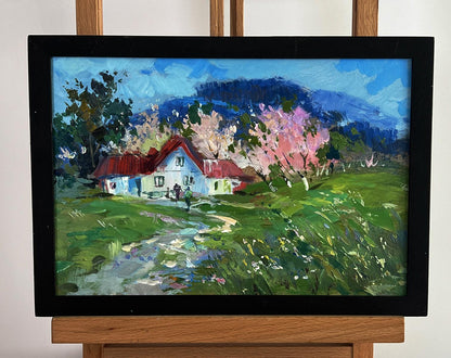 Oil painting of rustic white house with red roof among blooming cherry trees by Yuriy Suprunchuk