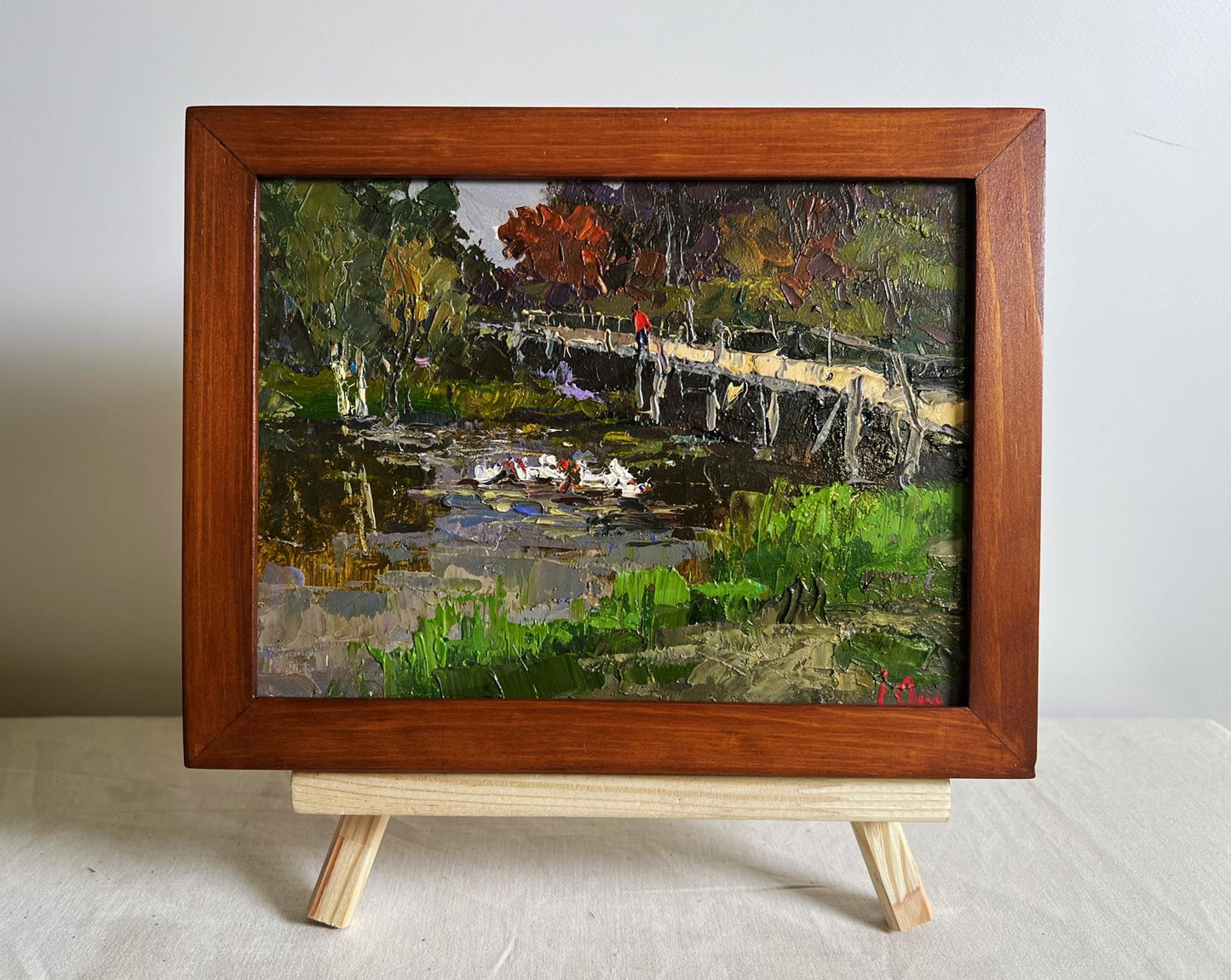 Oil painting by Oksana Ivanyuk: ducks on lake near bridge in autumn landscape