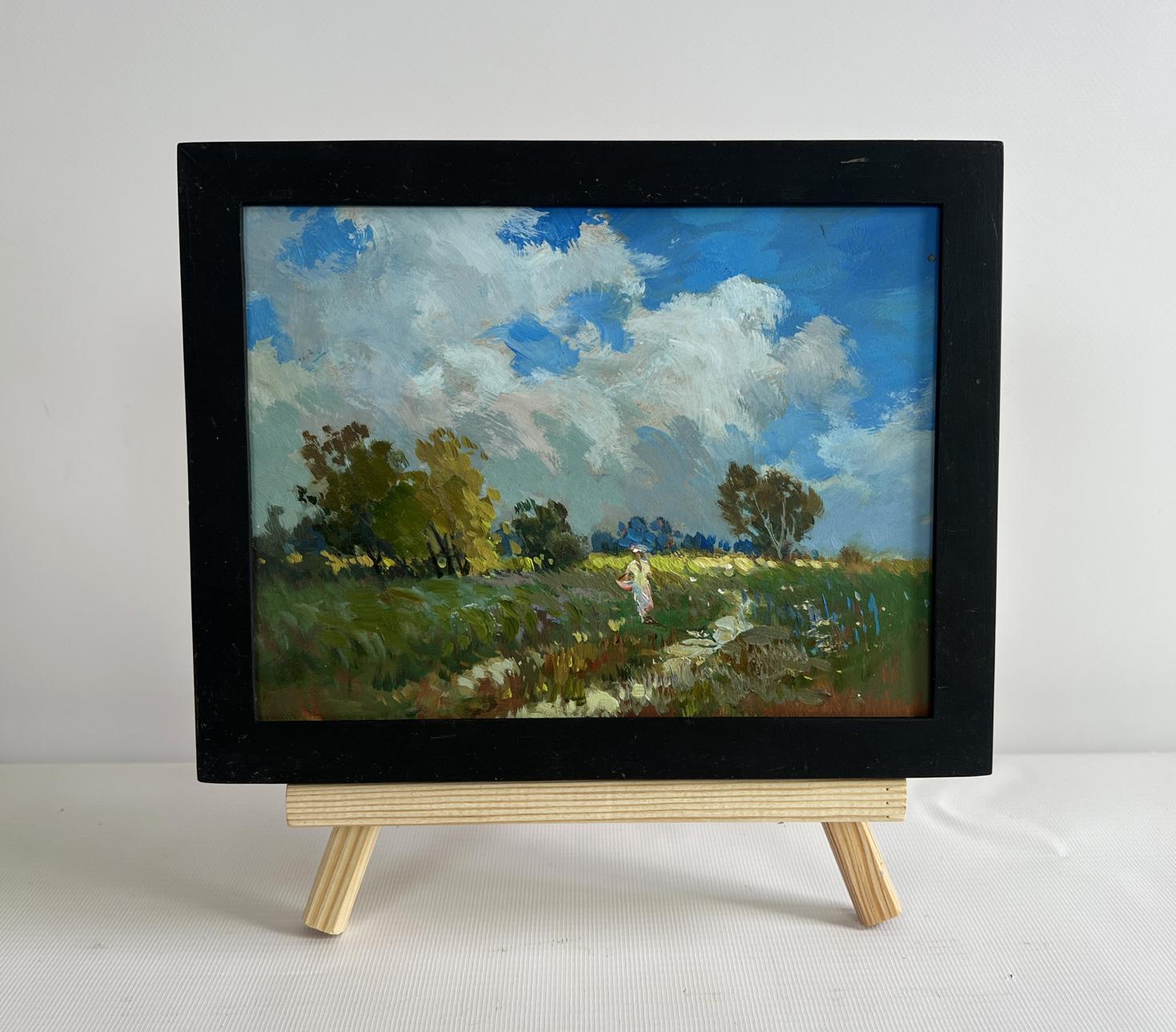 Framed oil painting of girl walking in vibrant green field by Yuriy Suprunchuk
