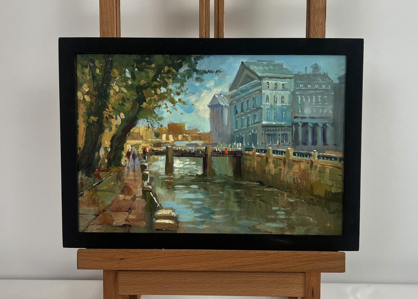 Black-framed oil painting of city canal by Yuriy Suprunchuk