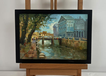 Black-framed oil painting of city canal by Yuriy Suprunchuk