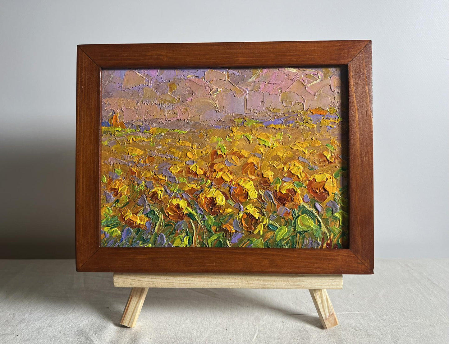 Vibrant impressionist oil painting of sunflower field by Oleksiy Ivanyuk in wooden frame