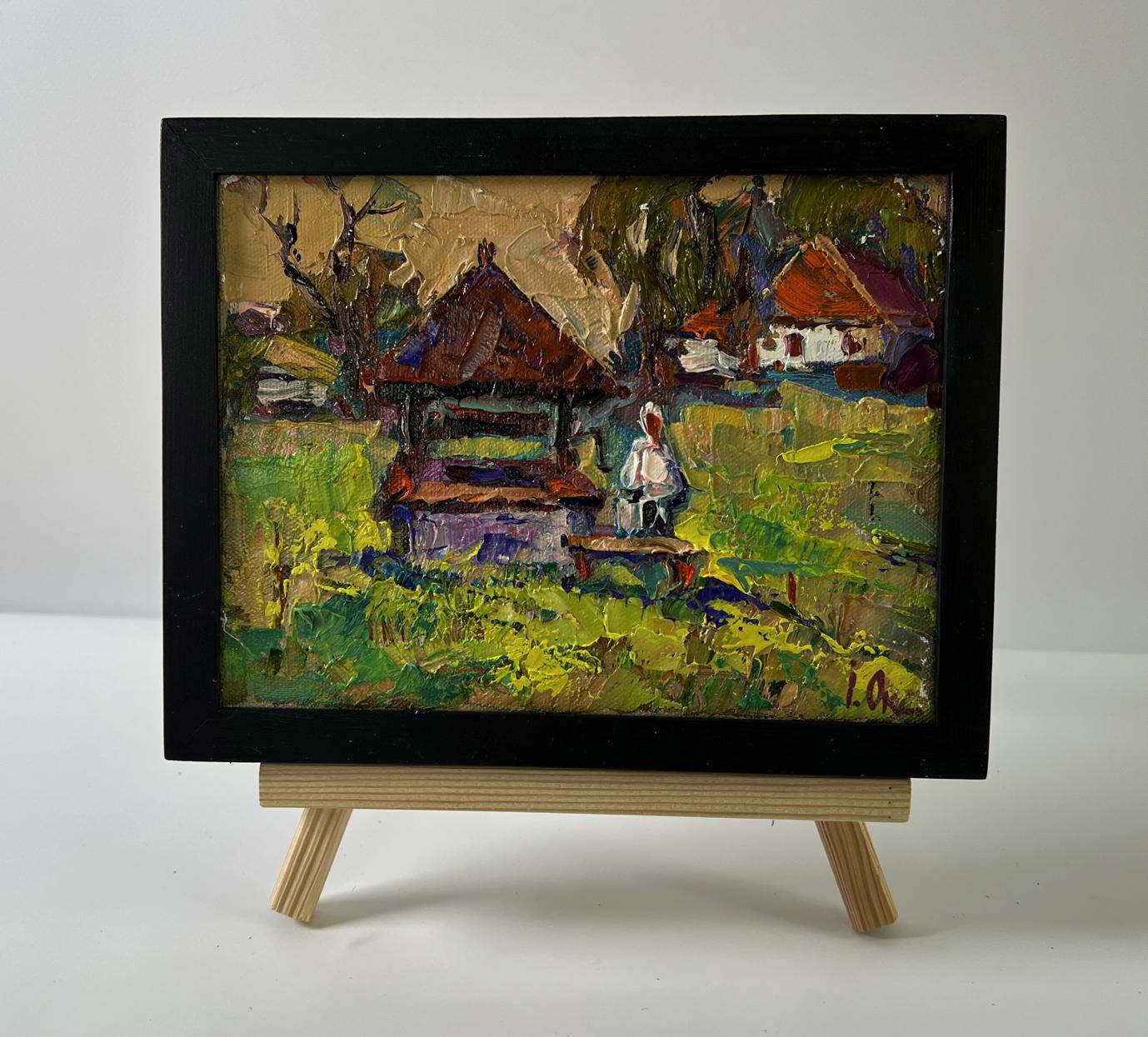 Oil painting of rustic village life by Oksana Ivanyuk in black frame