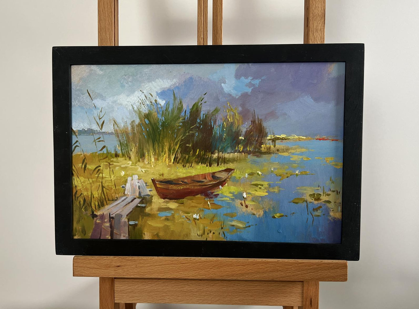 Oil painting of rowboat among reeds by Yuriy Suprunchuk