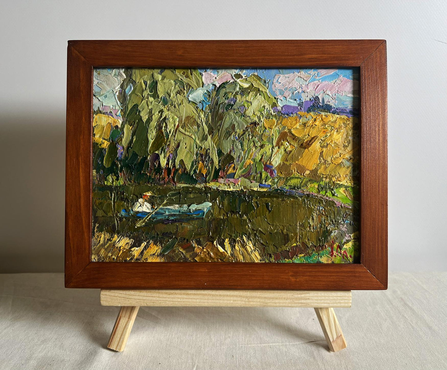 Oil painting On the summer lake by Oleksiy Ivanyuk with green trees and fields