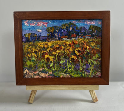 Vibrant oil painting of sunflower field in village by Oksana Ivanyuk in wooden frame