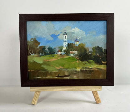 Oil painting of village church by Yuriy Suprunchuk in dark wooden frame