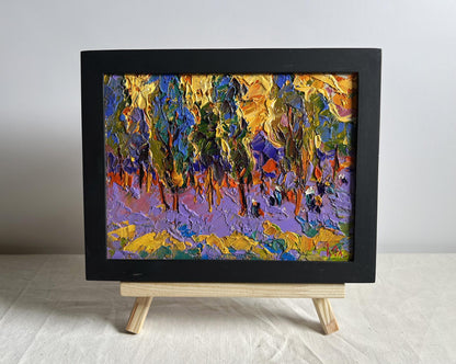 Oil painting of yellow sunset behind trees by Oleksiy Ivanyuk in black frame