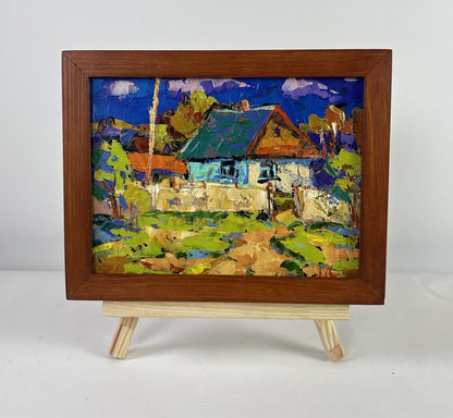 Vibrant impressionist oil painting of Oksana Ivanyuk tree house with green roof, blue walls in rustic frame