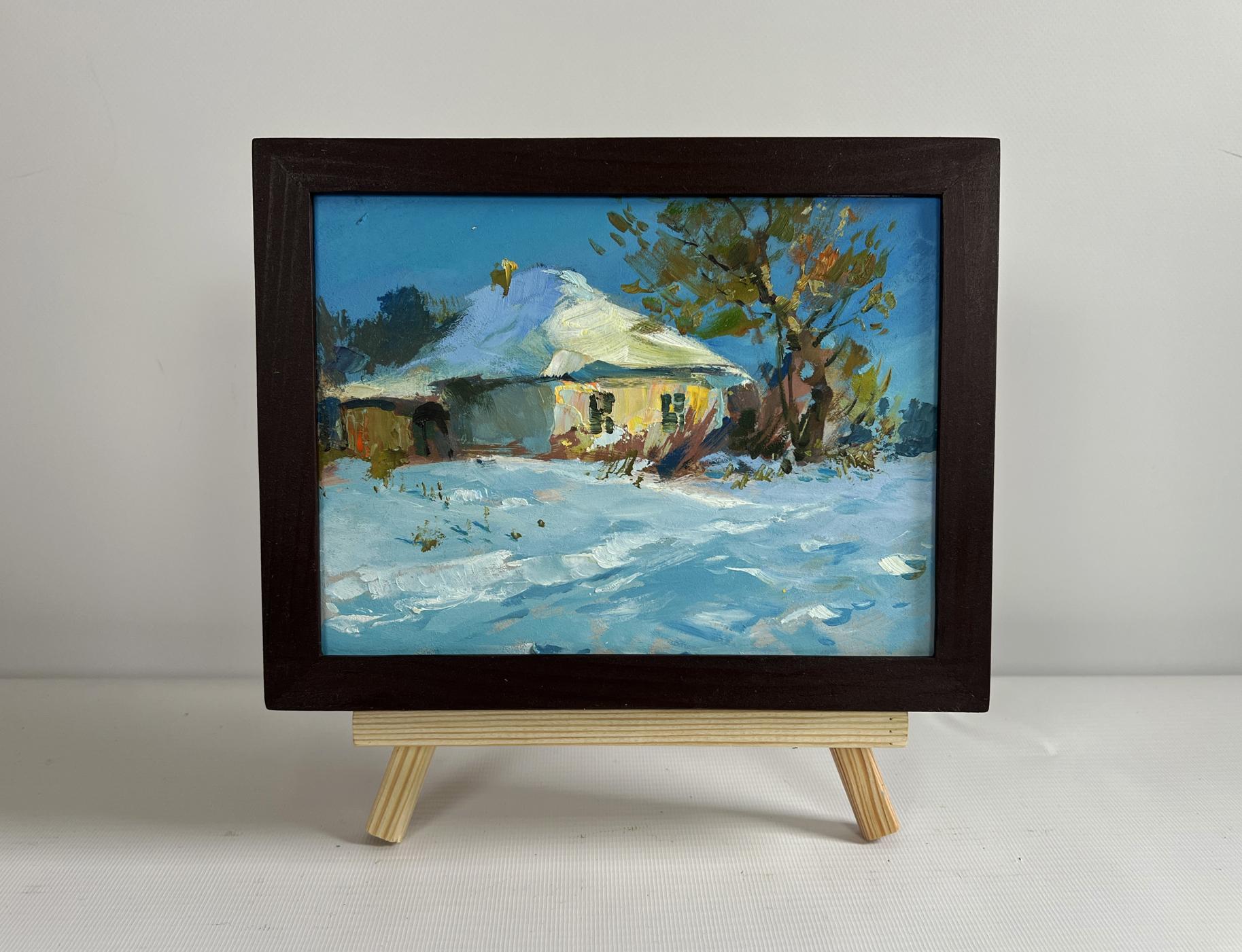 Framed oil painting of snowy rural scene with yellow house by Yuriy Suprunchuk