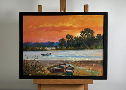 Oil painting Mesmerizing Crimson Sunset by Yuriy Suprunchuk in black frame on easel