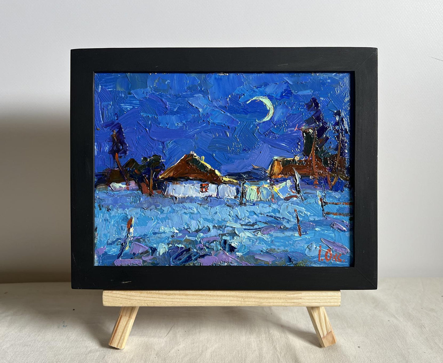 Oil painting Moonlit night by Oksana Ivanyuk: snowy village under crescent moon