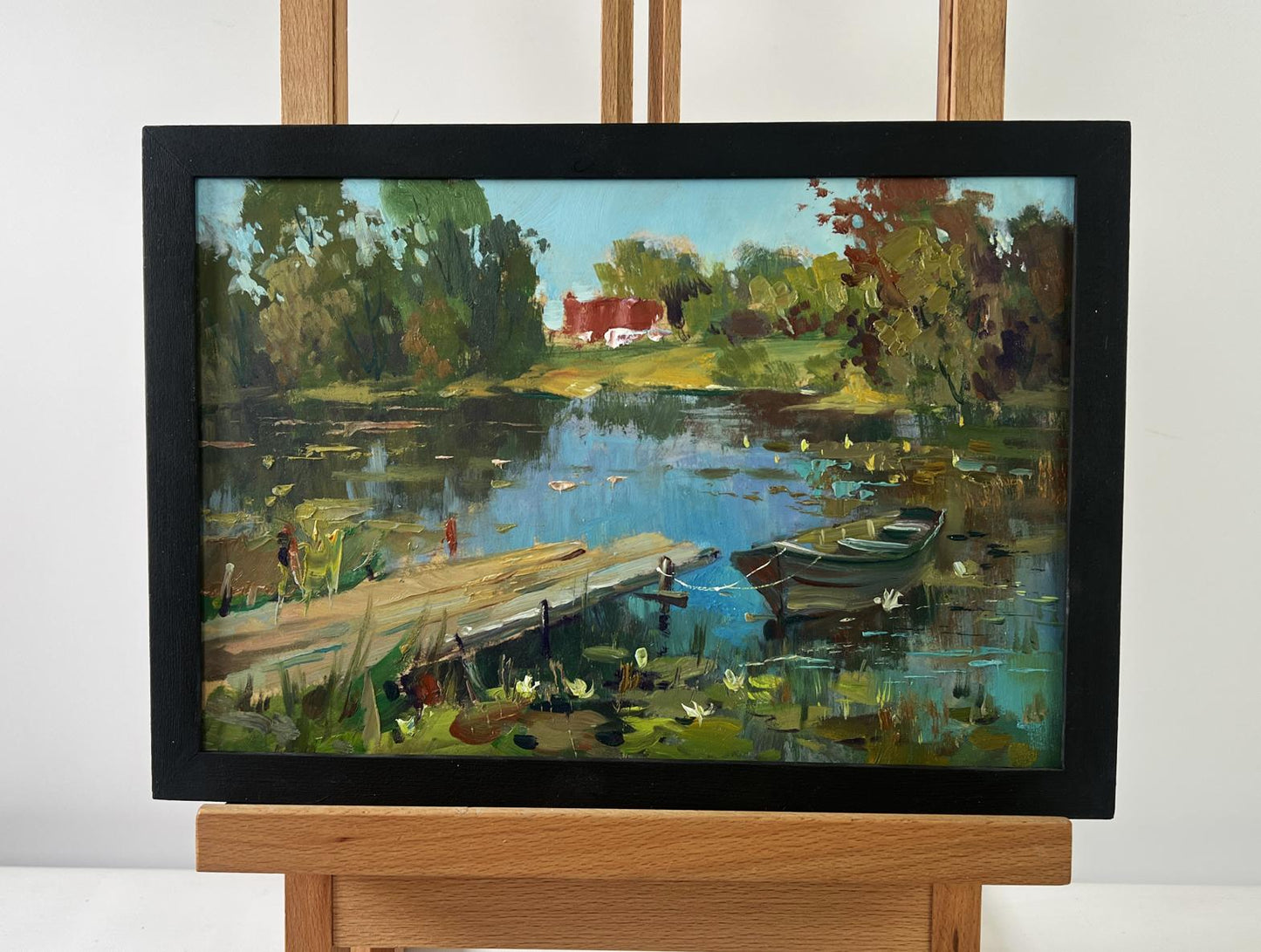Oil painting by Yuriy Suprunchuk: serene lakeside boat in lumber mill