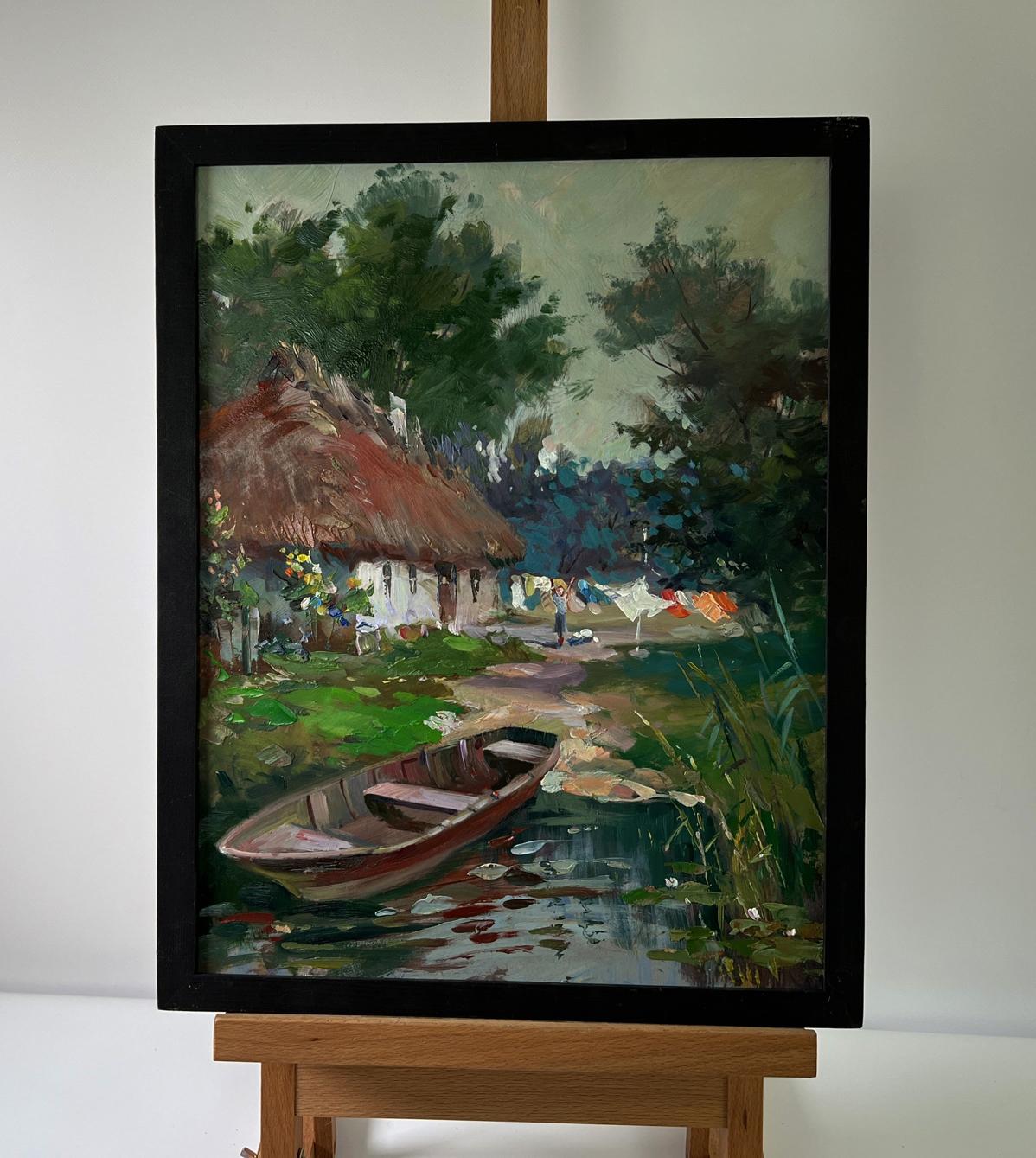 Oil painting Boat on the shore by Yuriy Suprunchuk: rustic cottage by pond