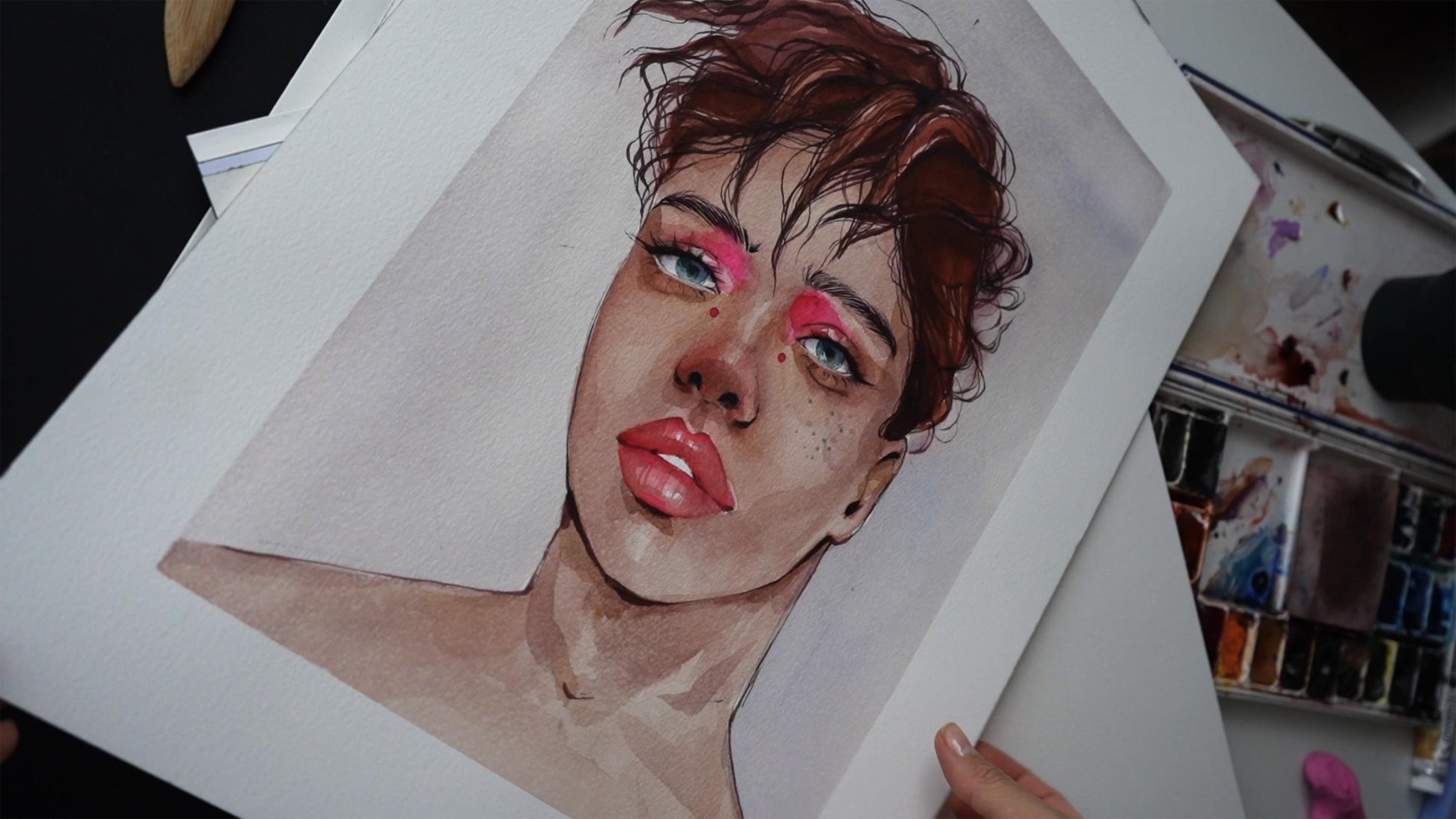 Watercolor portrait by Victoria Kagalovska, pink tint, reddish-brown hair, blue eyes