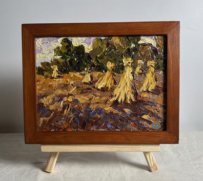 Oil painting by Oleksiy Ivanyuk: haystacks in fields, figures in yellow dresses