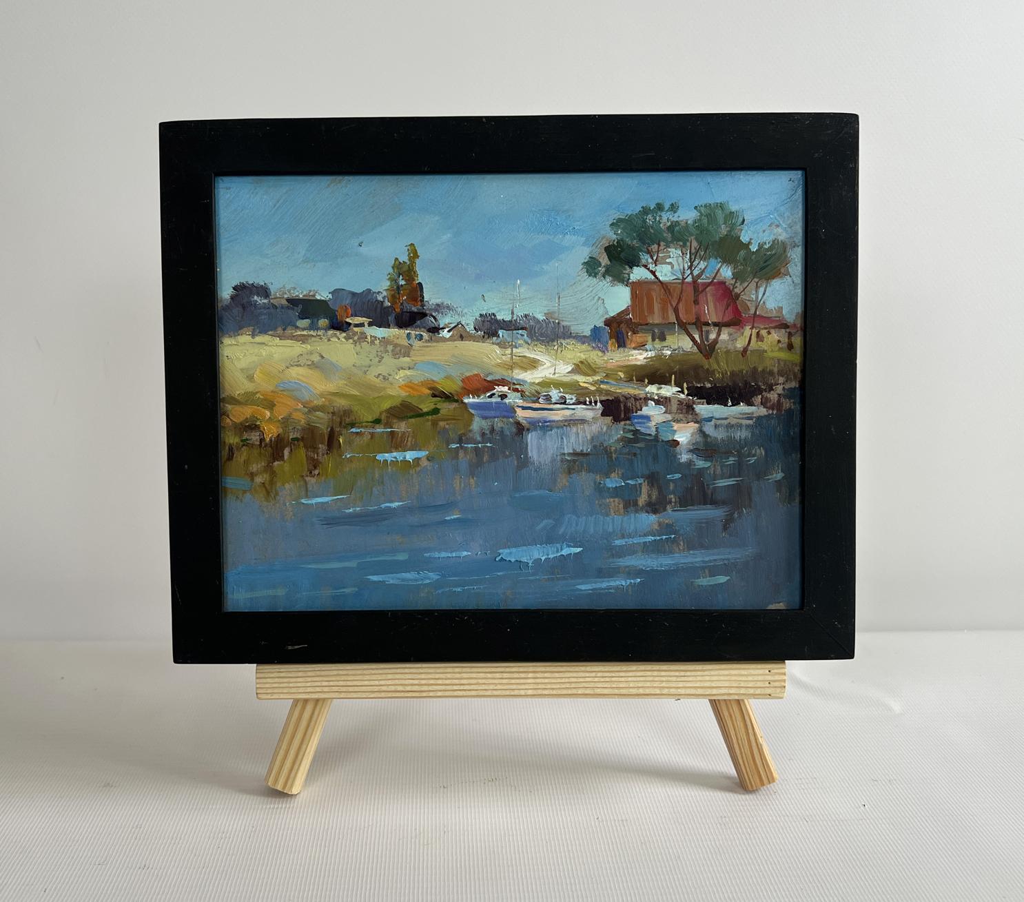 Small black-framed oil painting Sailboats on the shore by Yuriy Suprunchuk