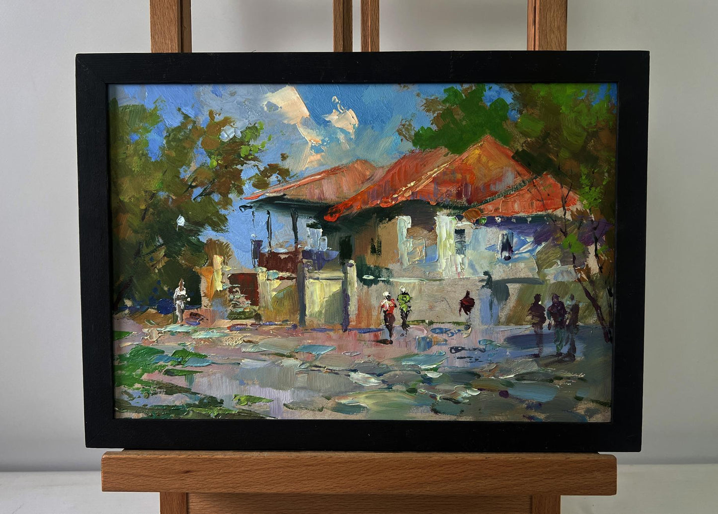 Vibrant impressionist oil painting of sunlit city village by Yuriy Suprunchuk in black frame