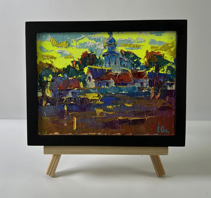 Vibrant impressionist oil painting by Oksana Ivanyuk of sunlit morning village in black frame