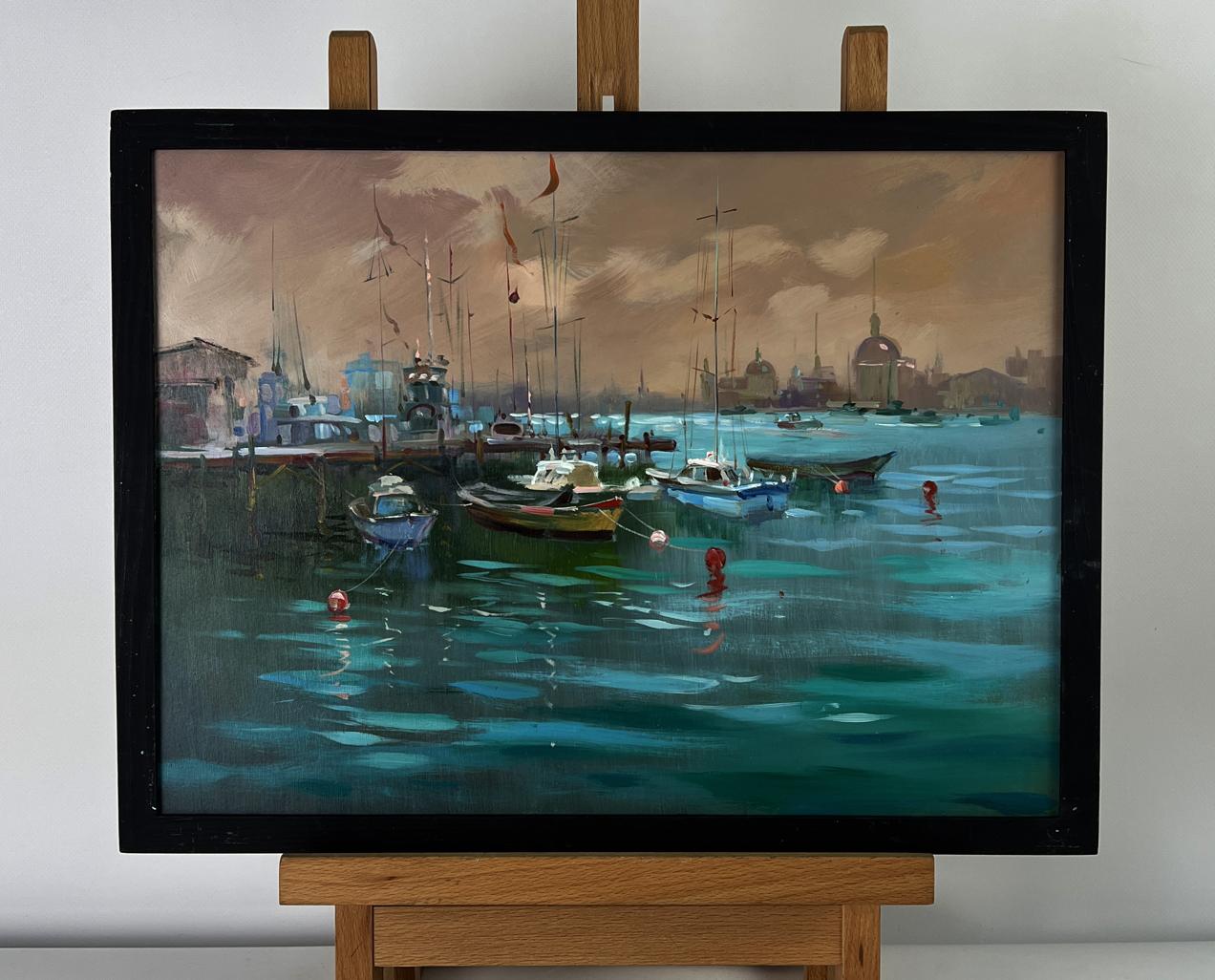 Oil painting Sunset at the city pier by Yuriy Suprunchuk in black frame on easel