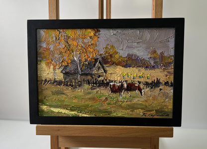 Oil painting by Boris Serdyuk: rustic autumn village with cows grazing