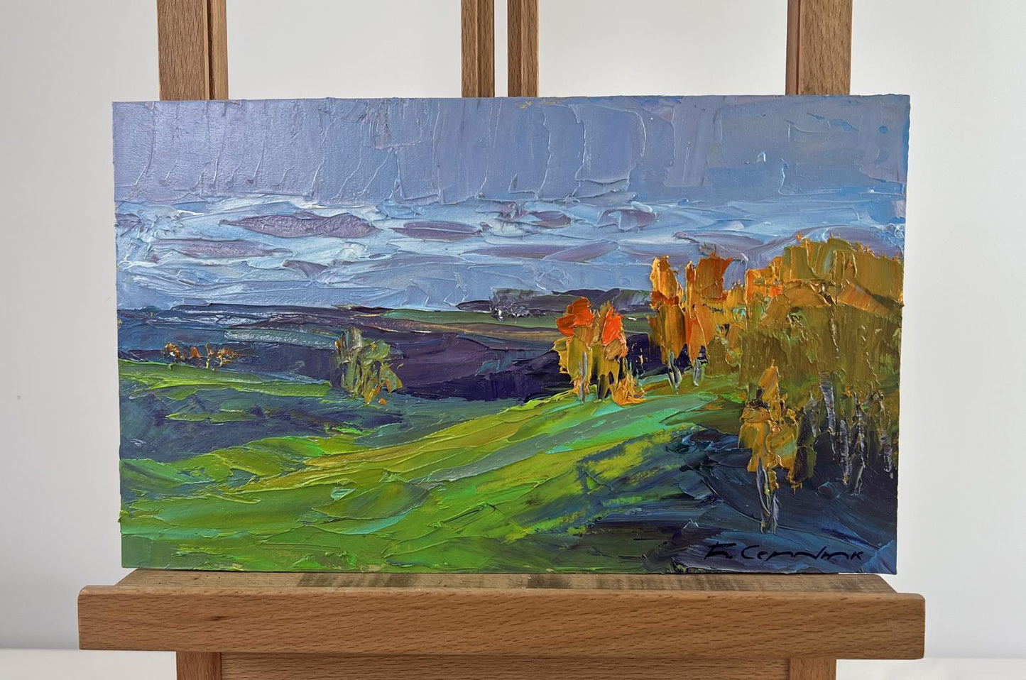 Vibrant impressionist oil painting by Boris Serdyuk: green hills, autumn trees, blue sky