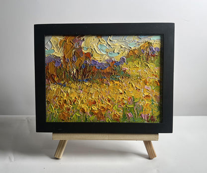 Oil painting of huge sunlit sunflower fields by Oleksiy Ivanyuk in black frame
