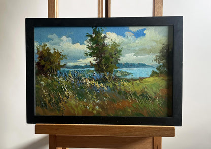Oil painting by Yuriy Suprunchuk: flower field, river, lush trees, serene water